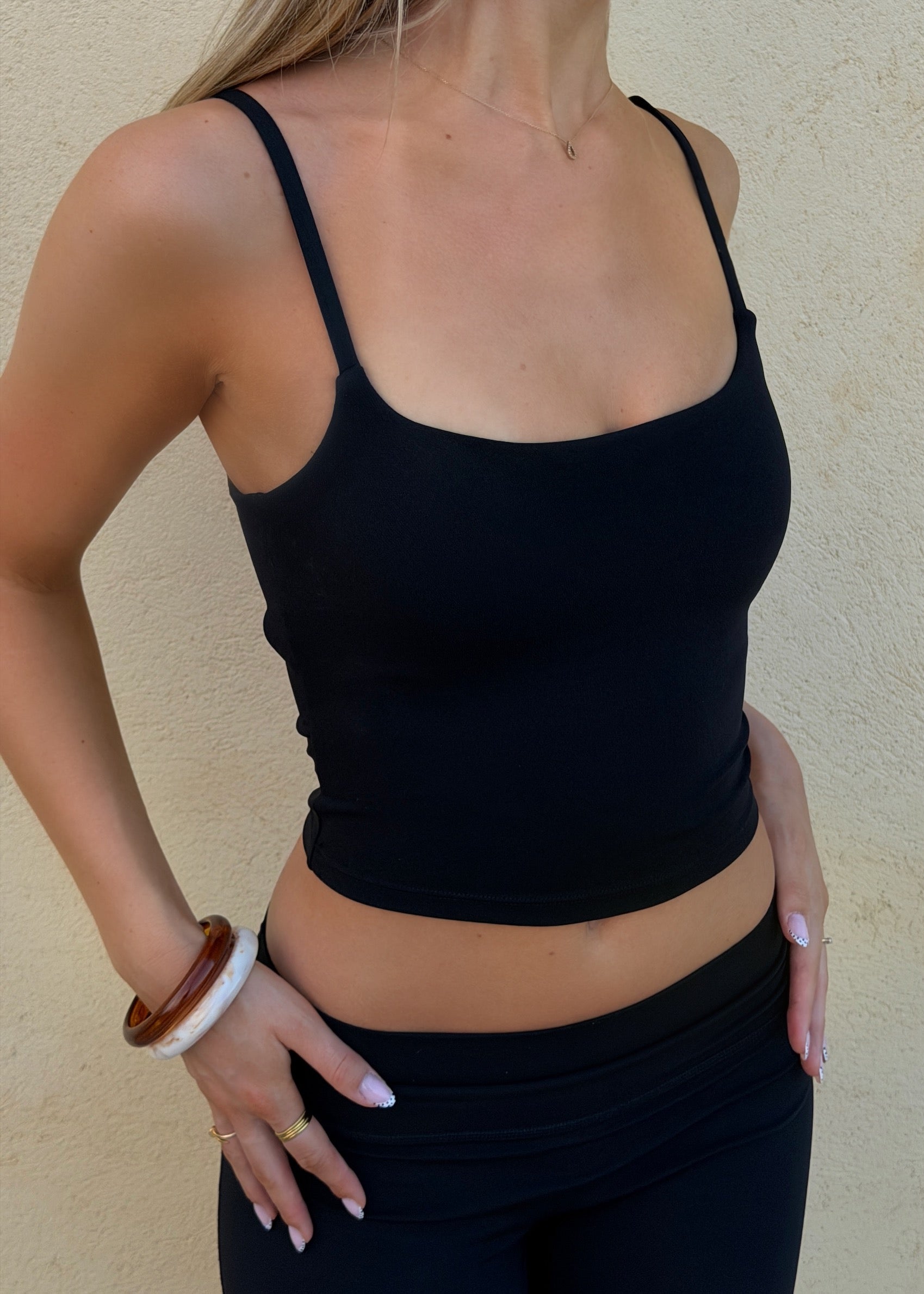 Model is wearing sculpt top in black