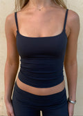 Model is wearing sculpt top in dark blue