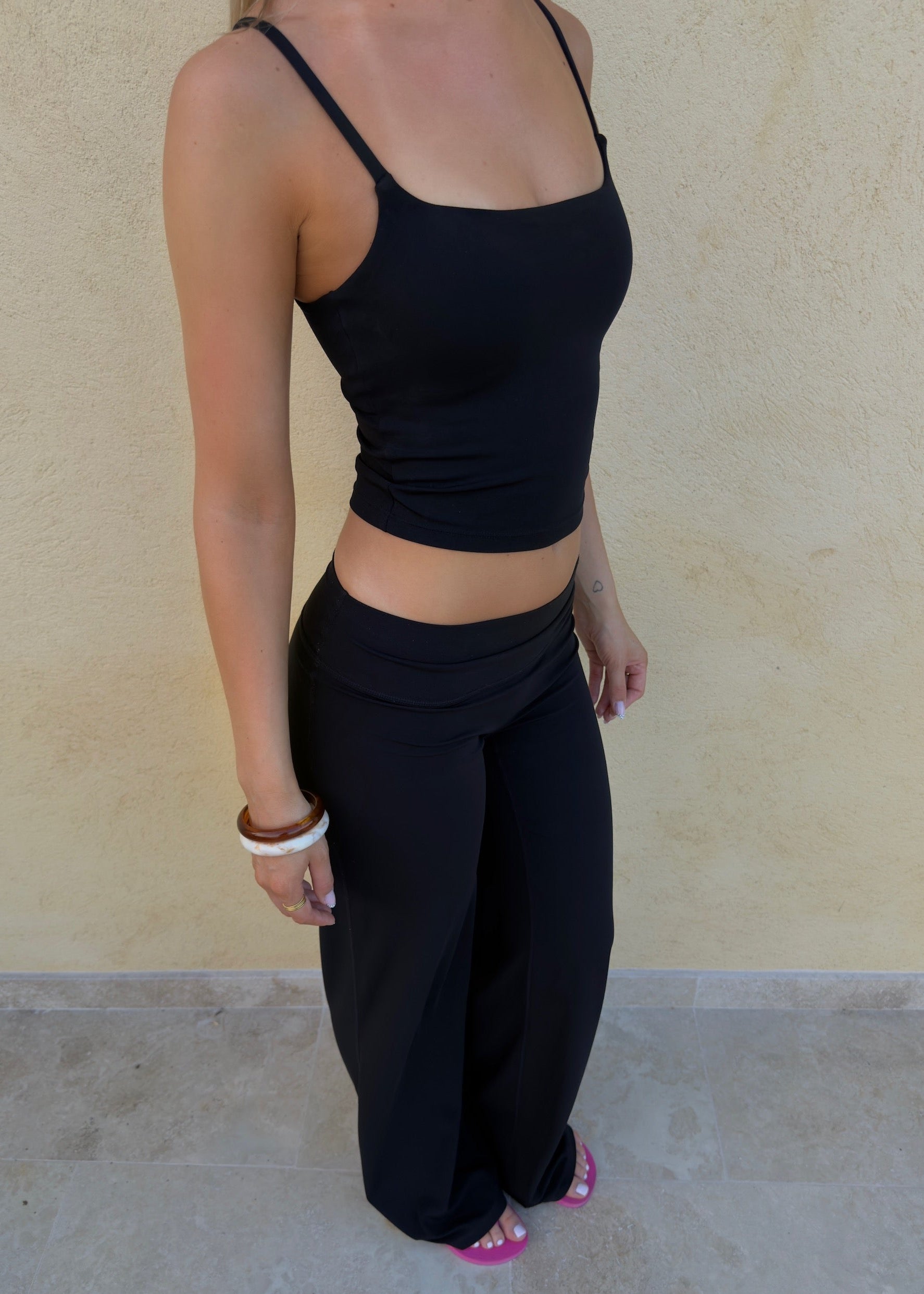 Model is wearing wide leg pants in black